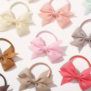 Detail shot of assorted solid color grosgrain ribbon bows hair ties for girls