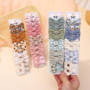 Cute girls hair clips set with plaid bows and crochet flowers in a decorative basket