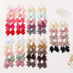 Flat lay of colorful grosgrain ribbon bow hair ties in a wide variety of pastel and solid shades