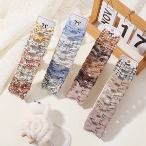 Detail of cute children's bow hair clips set with floral, plaid and polka dot patterns