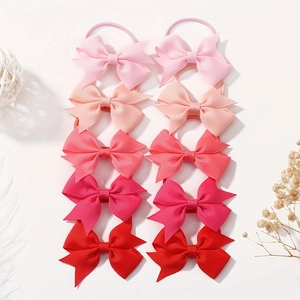 Detail view of 10pcs children's gradient pink bow hair ties set on a white background