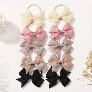 Detail view of 10-piece bow hair tie set in neutral tones on white background
