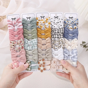 Selection of colorful fabric hair clip sets featuring floral, plaid and polka dot bow designs