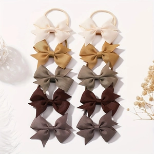 Detail of 10-piece bow hair tie set in five earthy tones with ribbed ribbon texture
