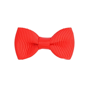 Detail of red ribbed fabric hair bow showing the textured material and central knot