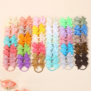Colorful set of 40 grosgrain ribbon bow hair ties in various vibrant and pastel shades