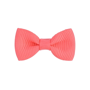 Detailed macro view of peach pink grosgrain ribbon bow with fine ribbed texture detail