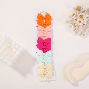 Set of 10 handmade grosgrain ribbon bow hair clips displayed on a white card