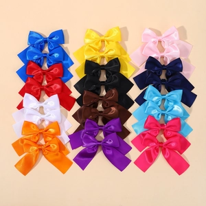 Detailed overhead view of 12 colorful satin bow hair clips in vibrant assorted candy colors