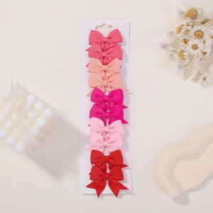Detailed set of 10 ribbon bow hair clips for girls displayed on a white product card