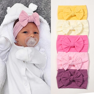 Pack of 6 soft nylon baby headbands with large bows in vibrant candy colors