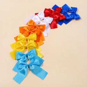 Detail of satin bow clips set in multiple colors including navy red and bright yellow