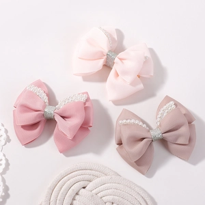 Pink bow hair clips set with pearls and glitter centers for girls' party accessories