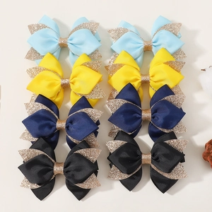 Detail of 8-piece glitter bow hair clips set in blue, yellow, navy and black colors