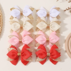 Detailed close-up of 8-piece bow hair clip set in white, yellow, pink, and red glitter