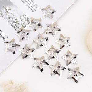 Detailed view of thirteen silver pentagram star hair clips on a clean white background