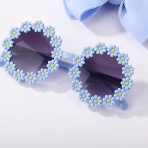 Close-up of kids light blue daisy sunglasses and matching soft nylon bow headband