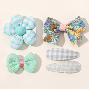 Detail view of 5-piece girls' hair clip set with floral bows and embroidered clips