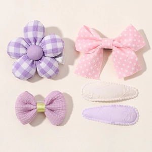 Flat lay detail of a 5-piece floral and bow hair clip set for toddler girls in pastel colors