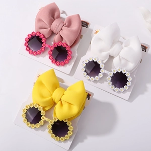 Detailed set of kids' daisy flower sunglasses and matching large bow nylon headbands