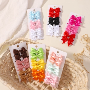 Set of 6 mini satin bow hair clips for baby girls in various vibrant colors on card