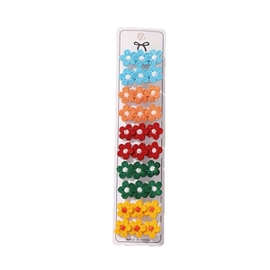 Set of 10 floral knit hair clips in multiple colors on a white display card