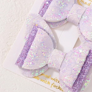 Détail macro de nœuds à cheveux à paillettes violettes et blanches avec texture dentelle