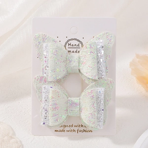 Détail de barrettes papillon en dentelle blanche faite main avec paillettes colorées