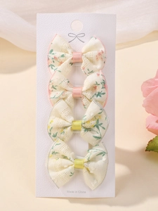 Detailed macro view of 4-piece floral lace bow hair clips set for kids on card