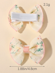Detail view of floral print hair bow with dimensions 1.88 inches and 2.1g weight