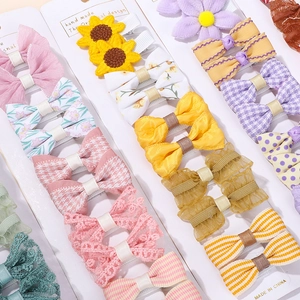 Detail view of colorful lace bows and sunflower hair clips for girls on display cards