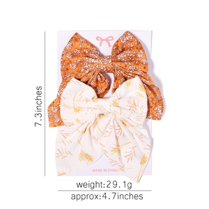 Lot de deux grands nœuds à cheveux de 18cm avec motifs floraux orange et blancs