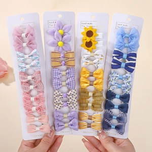 Close-up of handmade children's hair clip sets with plaid bows and floral details