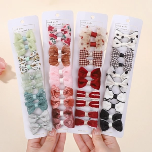 Detail shot of twenty cute floral and plaid hair clips on four white display cards