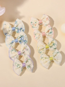 Detail view of colorful lace floral bow hair clips in pastel pink, blue and yellow
