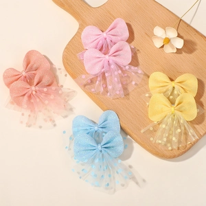 Sparkly bow hair clips for girls with mesh tassels in pink, orange, blue, and yellow