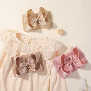 Detail showing large jacquard bow headbands in beige, coffee, and pink with a lace top