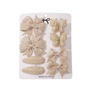 8-piece set of beige ribbon bows and knit hair clips for kids on display card