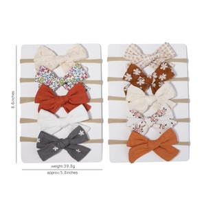10-piece set of elastic nylon baby headbands with assorted bow designs on display cards