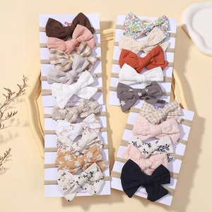 20-piece set of nylon baby headbands with assorted bows in floral and solid patterns