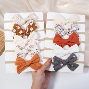 Detailed set of ten assorted nylon baby headbands with various bow designs and textures