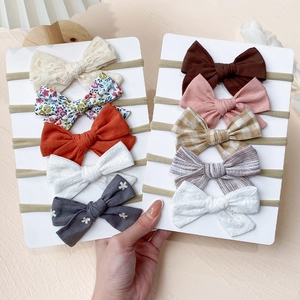 Detailed close-up of 10-piece baby nylon bow headband set with various floral patterns