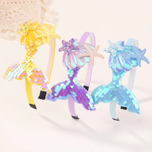 Detail of colorful sequined mermaid tail headbands with shell and starfish decor