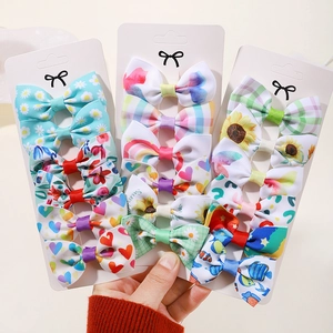 Détails des barrettes en ruban gros-grain avec motifs marguerites et arcs-en-ciel colorés