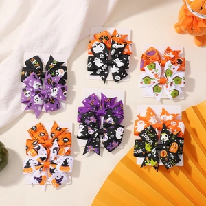 Set of 12 Halloween hair clips with pumpkin, ghost, and bat patterns on ribbon bows