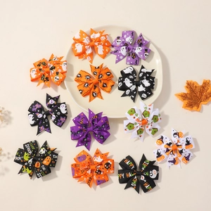 Flat lay of 12 Halloween grosgrain hair bows with pumpkin, ghost and bat patterns