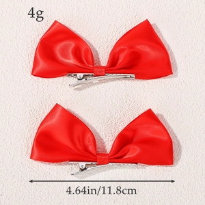 Pair of red satin bow hair clips for girls featuring silver metal duckbill hairpins