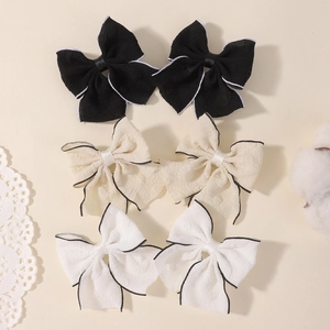 Three pairs of vintage fabric bow hair clips with contrast stitched edges for girls