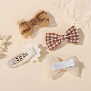 Close-up of cute bow hair clips set with plaid patterns and lace daisy flowers