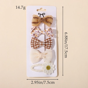 Detail view of 5-piece cute bow and daisy hair clips set on display card